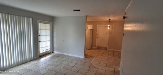 tiled spare room with a healthy amount of sunlight