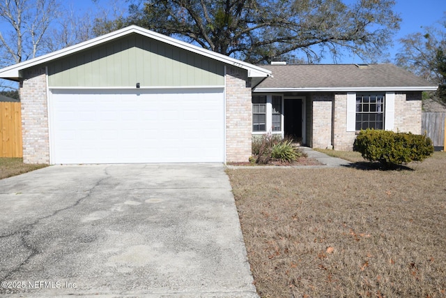 single story home with a front yard and a garage