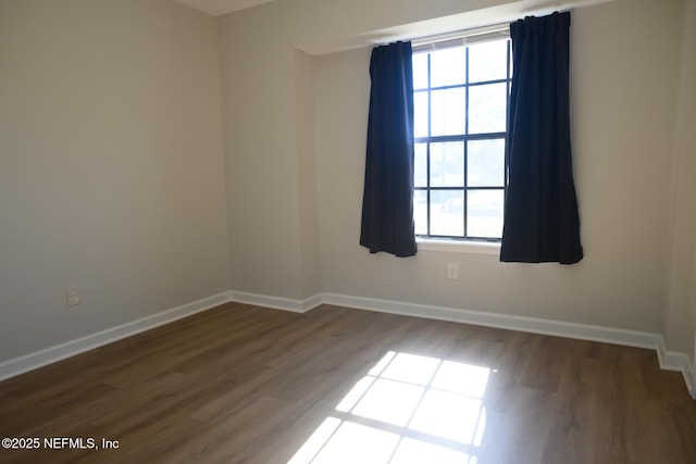 spare room featuring dark hardwood / wood-style flooring