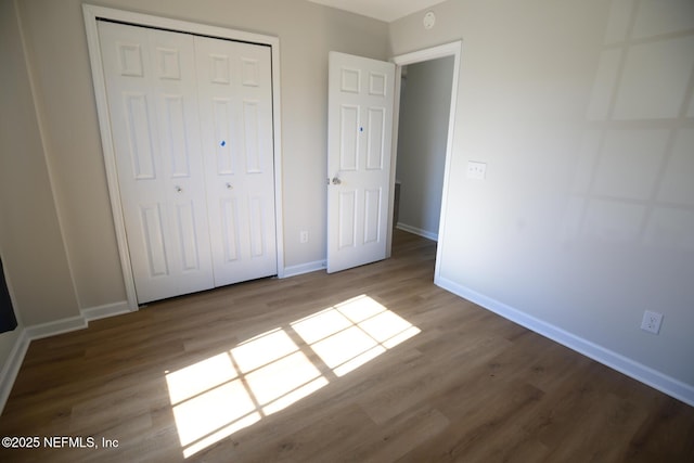 unfurnished bedroom with a closet and light hardwood / wood-style flooring