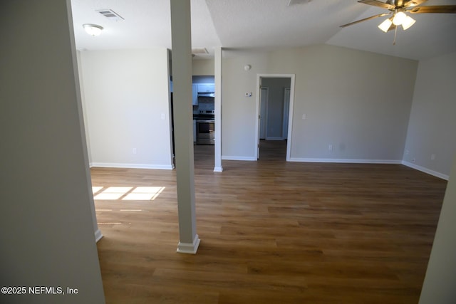 spare room with ceiling fan, dark wood-type flooring, and lofted ceiling