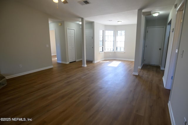 unfurnished room featuring ceiling fan and dark wood-type flooring