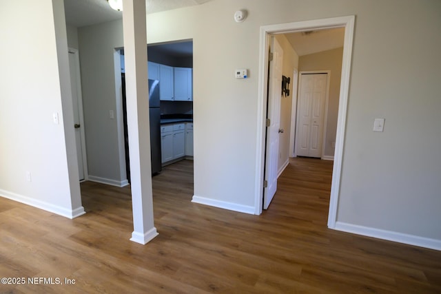 corridor featuring wood-type flooring