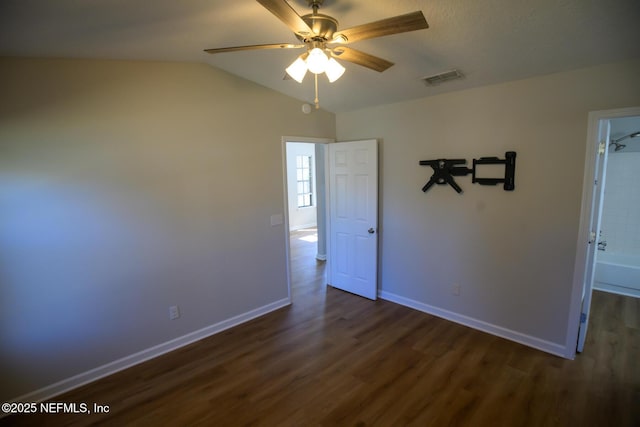 empty room featuring ceiling fan, dark hardwood / wood-style flooring, and lofted ceiling