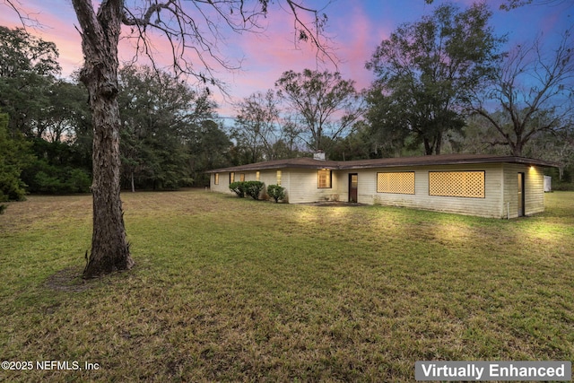 single story home featuring a yard