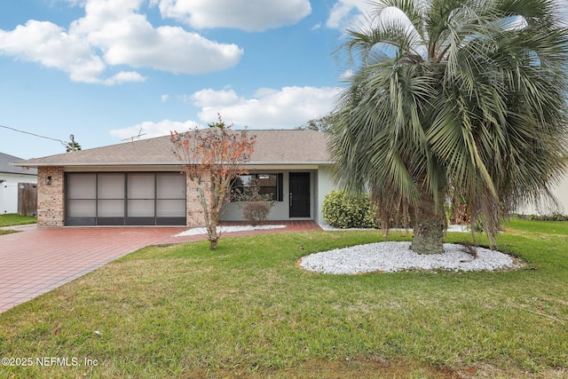 view of front of home with a garage and a front lawn