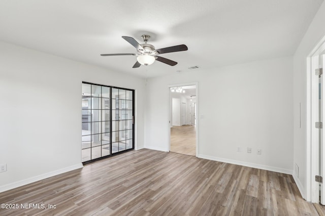 empty room featuring ceiling fan and light wood-type flooring