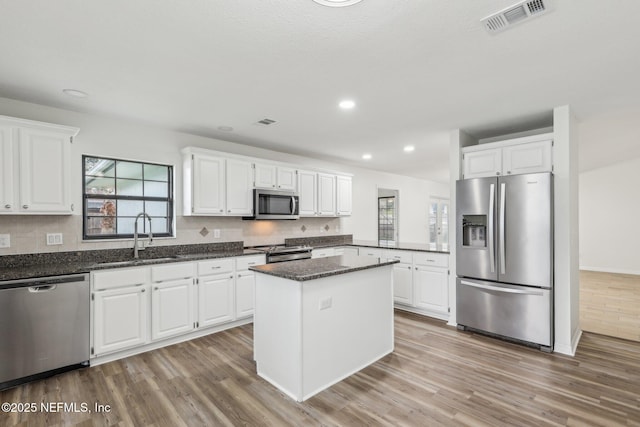 kitchen with sink, stainless steel appliances, and white cabinetry