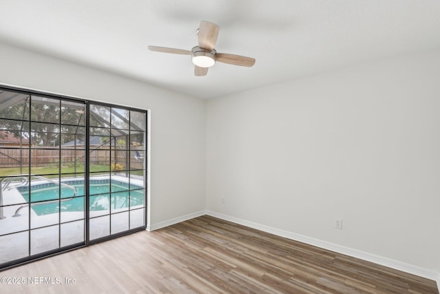 unfurnished room featuring light wood-type flooring and ceiling fan