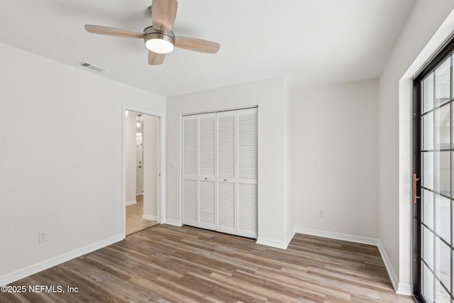 unfurnished bedroom featuring ceiling fan, a closet, and light hardwood / wood-style flooring