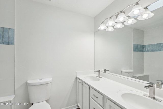 bathroom with toilet and vanity