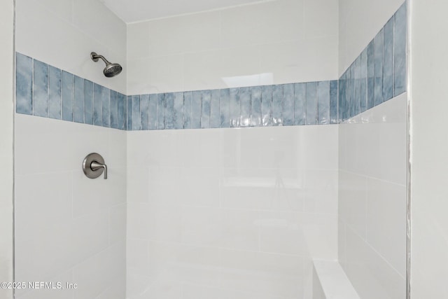 bathroom with tiled shower