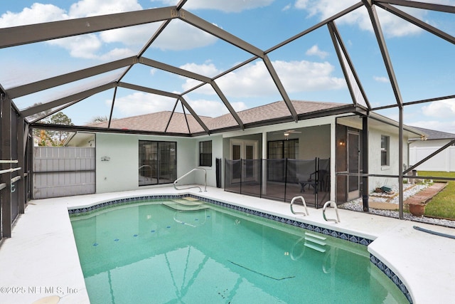 rear view of property with glass enclosure and a patio