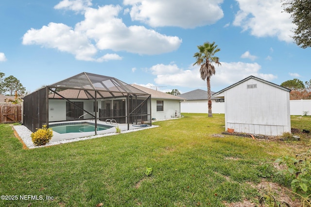 view of yard with a fenced in pool and glass enclosure