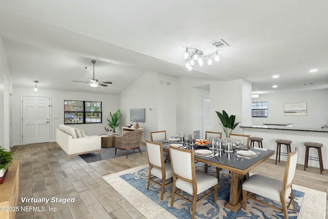 dining space featuring vaulted ceiling