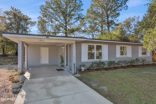 ranch-style house featuring a front yard and a carport