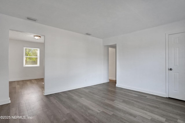 empty room featuring dark hardwood / wood-style flooring