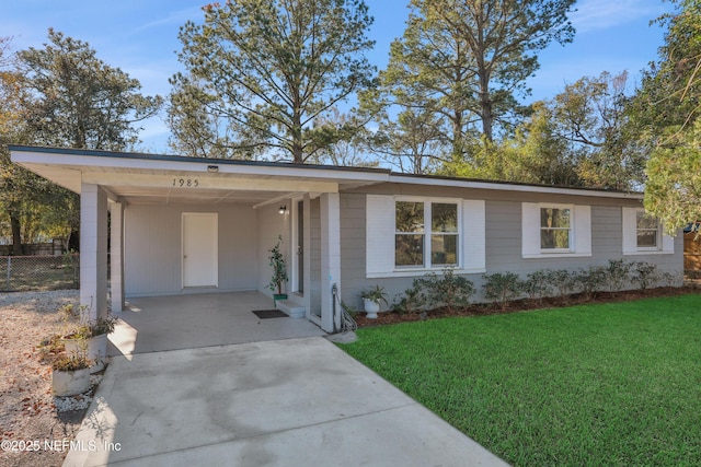 ranch-style home featuring a front yard and a carport