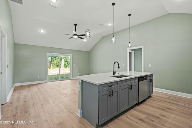 kitchen featuring a kitchen island with sink, dishwasher, sink, and gray cabinetry