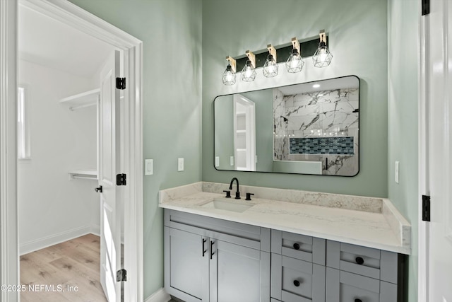 bathroom with vanity, wood-type flooring, and a shower