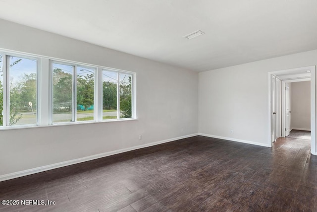 unfurnished room with dark hardwood / wood-style floors