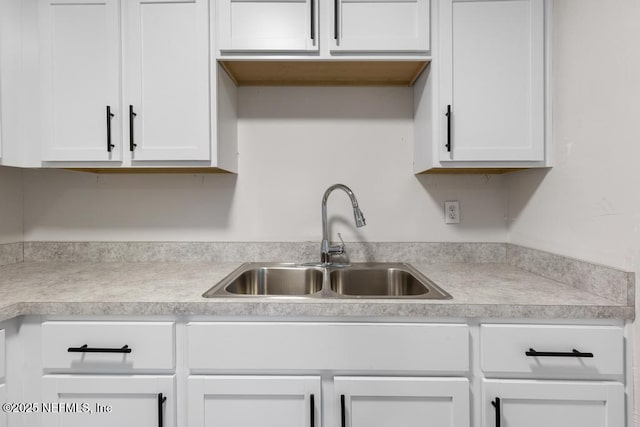 kitchen featuring white cabinets and sink