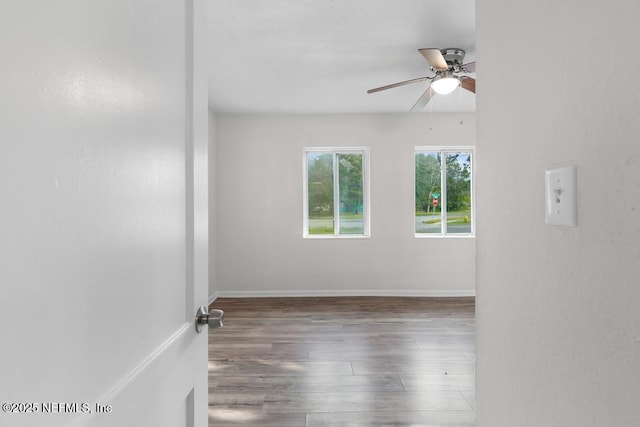 spare room with ceiling fan and wood-type flooring