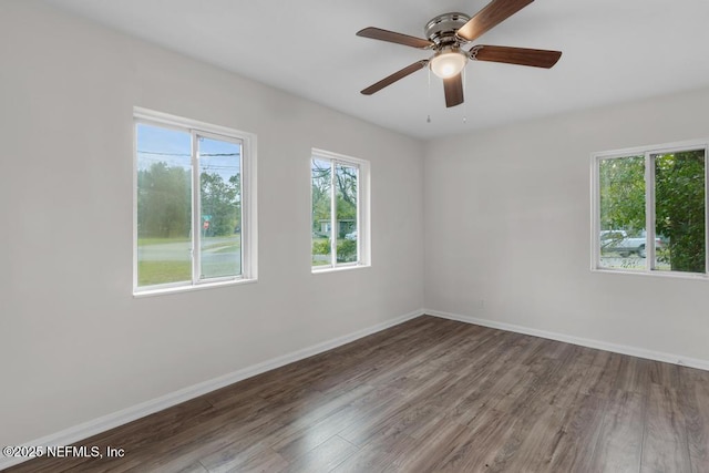 unfurnished room with ceiling fan and dark hardwood / wood-style flooring