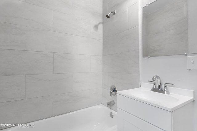 bathroom with vanity and tiled shower / bath combo