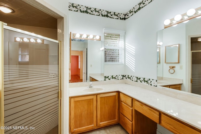 bathroom featuring tile patterned flooring, vanity, and an enclosed shower