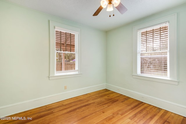 spare room with ceiling fan and hardwood / wood-style flooring