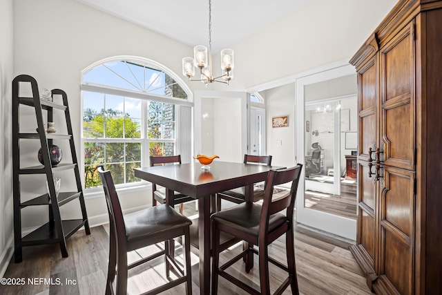 dining area featuring a notable chandelier and light hardwood / wood-style flooring