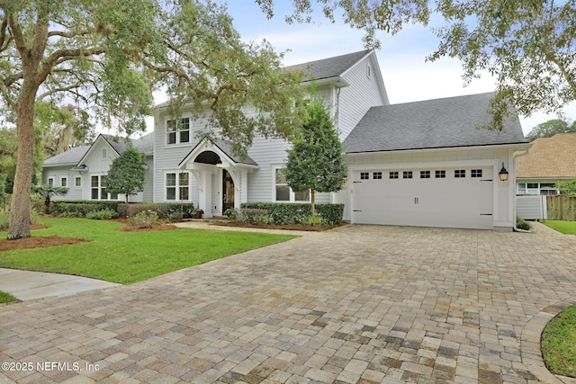 view of front of home featuring a front lawn and a garage