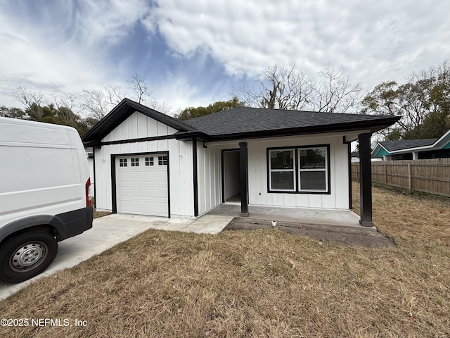 single story home featuring a front lawn, a porch, and a garage