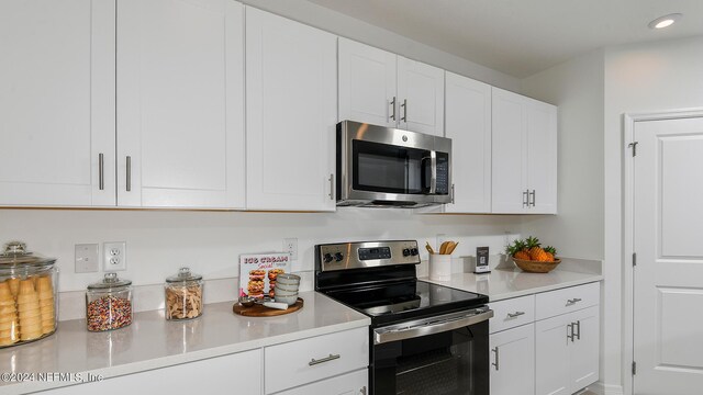 kitchen featuring white cabinets and appliances with stainless steel finishes