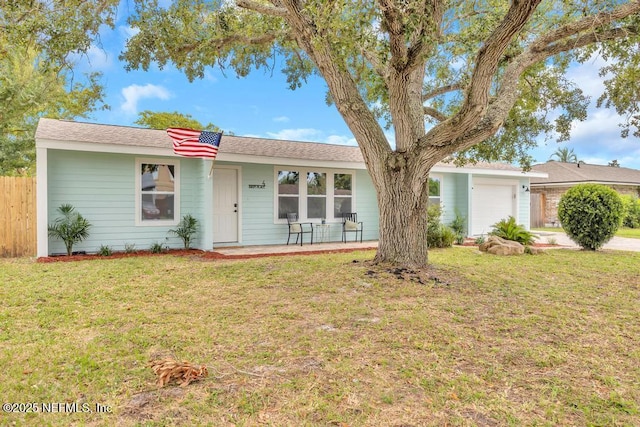 ranch-style house featuring a front yard and a garage