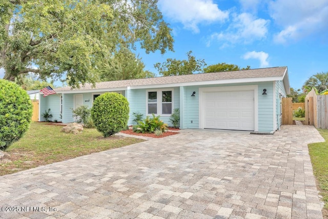 single story home with a front yard and a garage