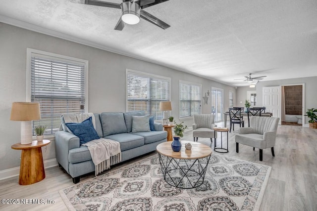 living room with a textured ceiling, ceiling fan, and light hardwood / wood-style floors