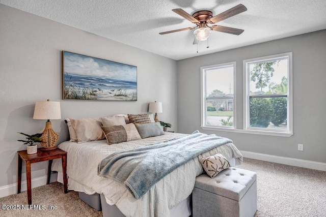 carpeted bedroom featuring a textured ceiling and ceiling fan