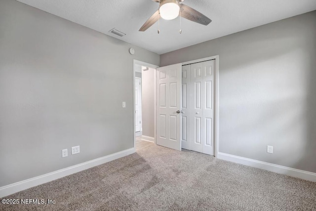 unfurnished bedroom with a closet, ceiling fan, and carpet