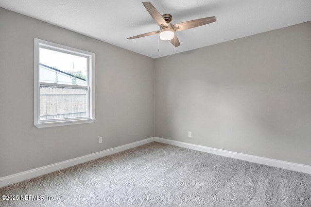 carpeted empty room featuring ceiling fan