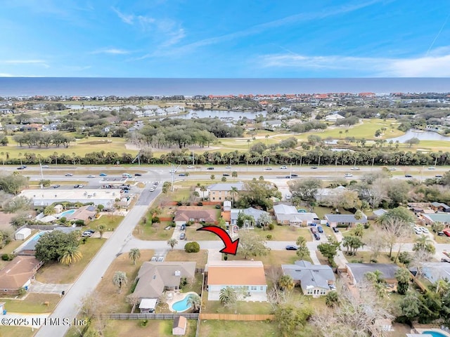 birds eye view of property with a water view