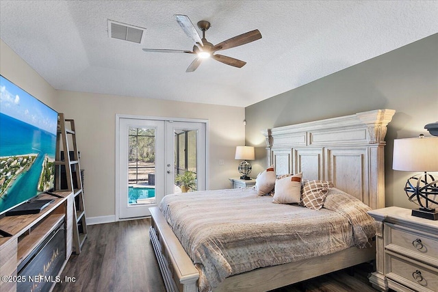 bedroom featuring dark hardwood / wood-style floors, access to outside, ceiling fan, a textured ceiling, and french doors