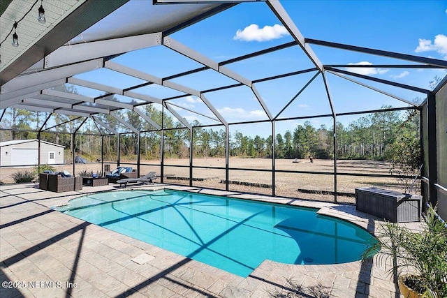 view of pool featuring a lanai, outdoor lounge area, and a patio area