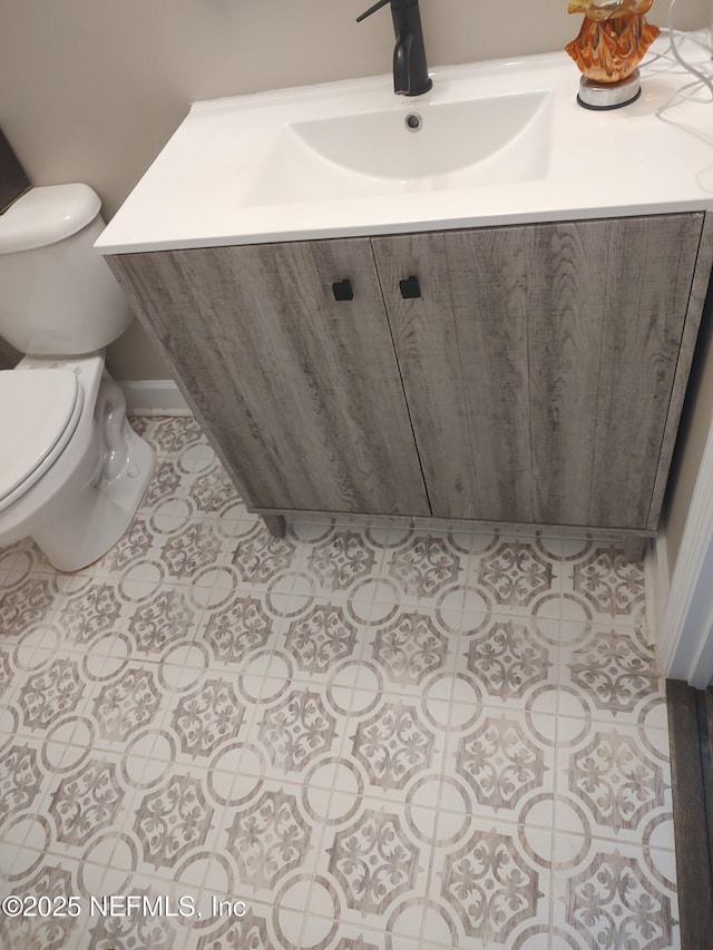 bathroom with vanity, tile patterned floors, and toilet