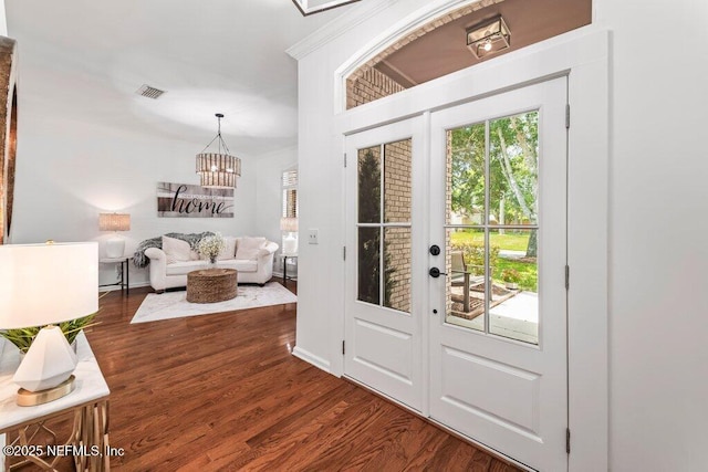 1814 Royal Fern Ln, Fleming Island, FL 32003 - foyer entrance featuring a chandelier, wood finished floors, baseboards, and ornamental molding