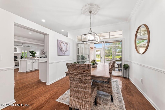 1814 Royal Fern Ln, Fleming Island, FL 32003 - dining space featuring ornamental molding, a chandelier, plenty of natural light, dark wood-style flooring, and baseboards