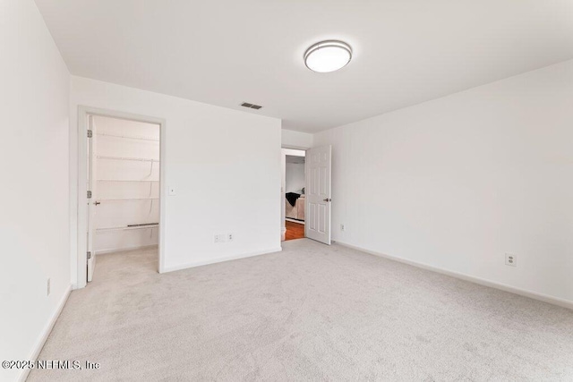 1814 Royal Fern Ln, Fleming Island, FL 32003 - unfurnished bedroom with carpet flooring, a walk in closet, baseboards, and a closet