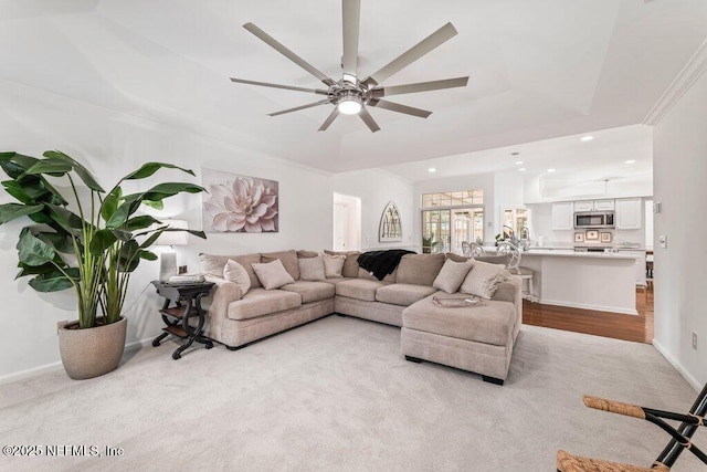 1814 Royal Fern Ln, Fleming Island, FL 32003 - living room featuring a tray ceiling, a ceiling fan, recessed lighting, baseboards, and light colored carpet