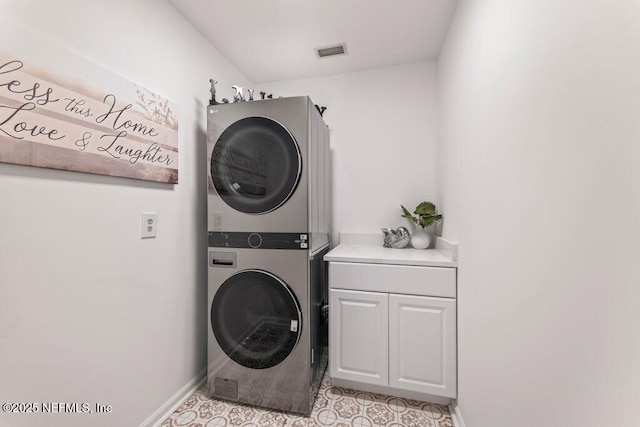 1814 Royal Fern Ln, Fleming Island, FL 32003 - washroom with estacked washer and dryer, cabinet space, baseboards, and light tile patterned flooring